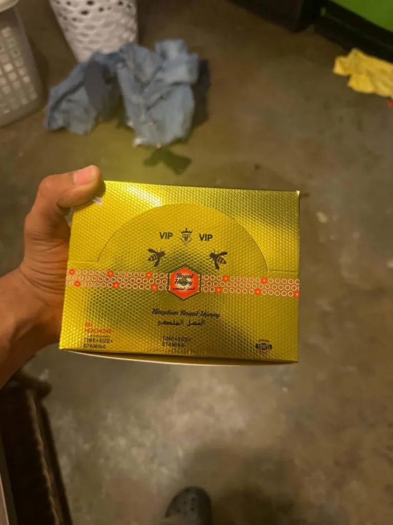 Customer photo: a customer holding a gold royal honey box